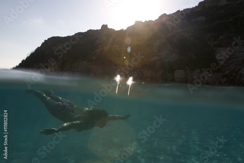 A woman swimming under the water. photo