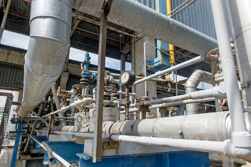Industrial equipment and pipelines at the gas processing plant on a summer day