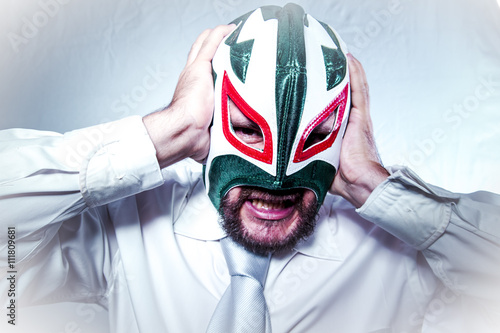 angry businessman with Mexican wrestler mask, expressions of ang photo