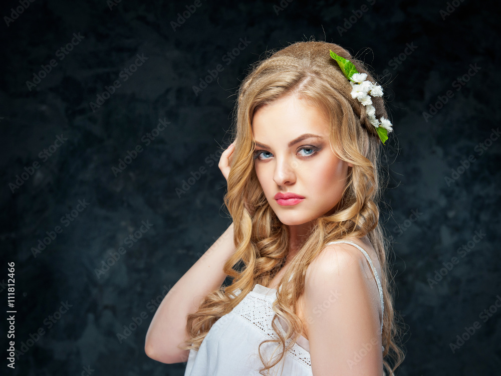 beautiful blonde girl in a wreath of flowers