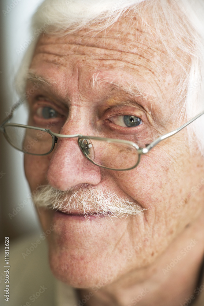 Close-up on an old man with moustache and glasses. Close-up on an old man with moustache and glasses.
