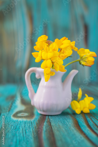 Bouquet of yellow lathyrus. Macro close-up photo with soft focus  bouquet of lathyrus flowers. Rustic colored beautiful wooden background