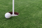 Golf ball and Flagstick of Mancured grass of putting green