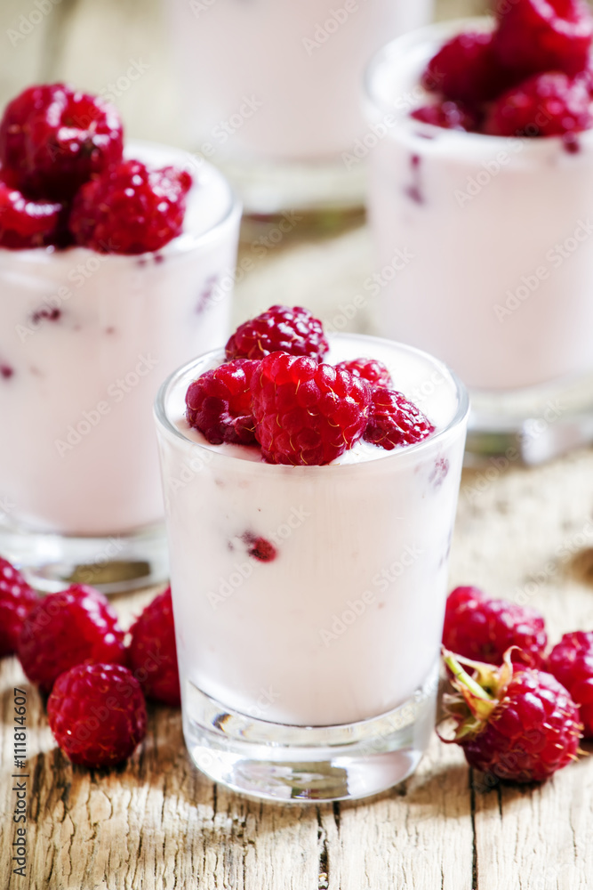 Homemade Pink Raspberry yogurt with fresh berries in glasses, vi Homemade Pink Raspberry yogurt with fresh berries in glasses, vi