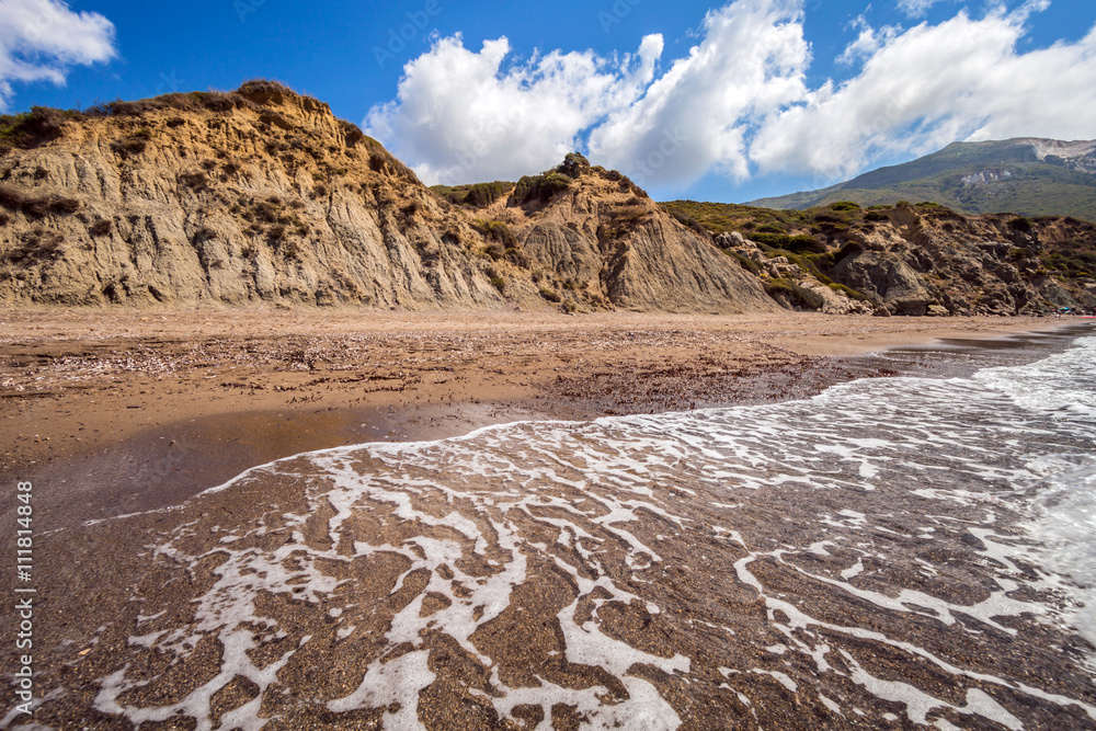 Sandy beach with cliffs in hot summer day Kalamaki Zakynthos Greece