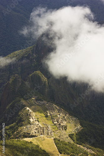 old town machu-picchu,peru, with surrounding mountains and clouds