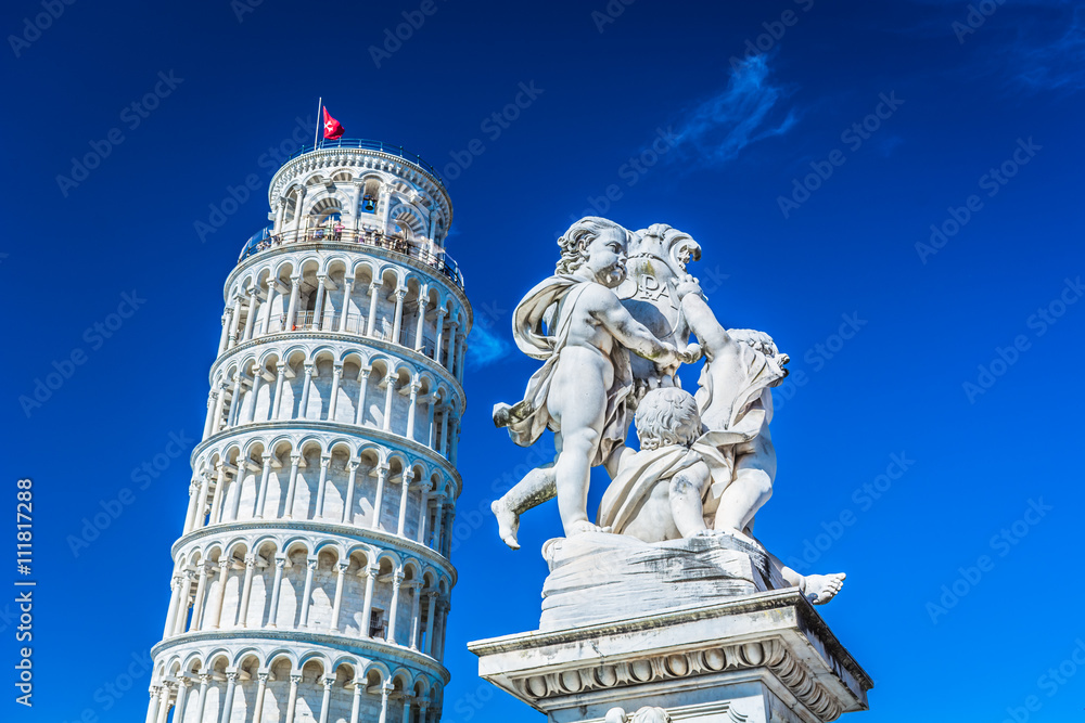 Famous leaning tower Pisa Italy. / Famous leaning tower in Pisa Italy with statue of angels in foreground.