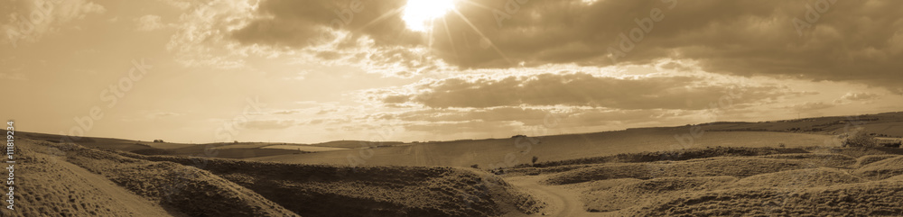Panoramic view over Maiden Castle in Dorset England black and white split toning photography Panoramic view over Maiden Castle in Dorset England black and white split toning photography
