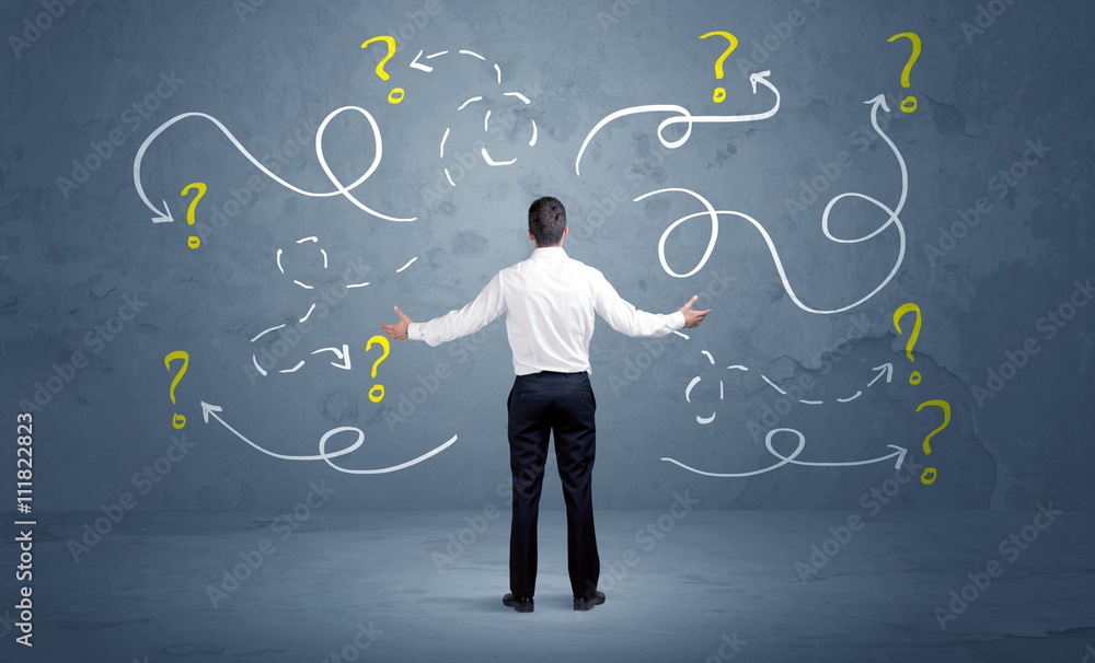Unsure businessman with question marks