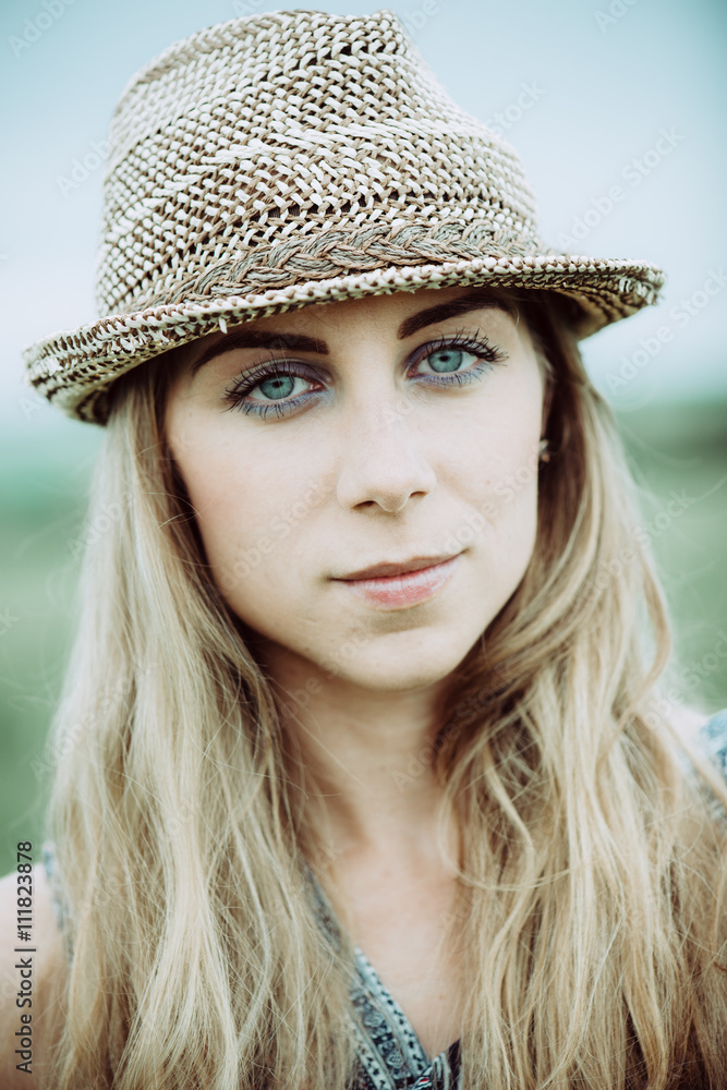Portrait of pretty woman wearing white dress and straw hat in sunny warm weather day. Close up portrait. Portrait of pretty woman wearing white dress and straw hat in sunny warm weather day. Close up portrait.