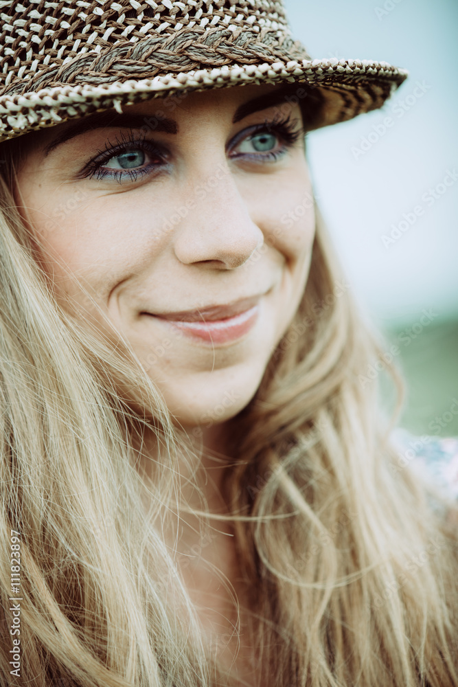 Portrait of pretty cheerful woman wearing white dress and straw hat in sunny warm weather day. Walking at summer park and smiling Portrait of pretty cheerful woman wearing white dress and straw hat in sunny warm weather day. Walking at summer park and smiling