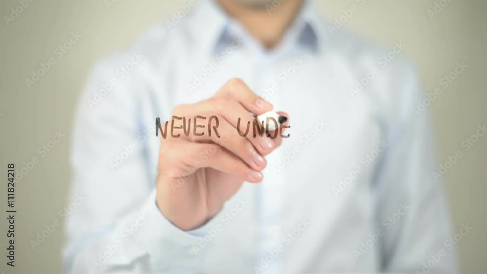 Never Undervalue Yourself , man writing on transparent screen Never Undervalue Yourself , man writing on transparent screen