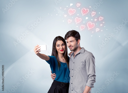 Couple in love taking selfie with red heart