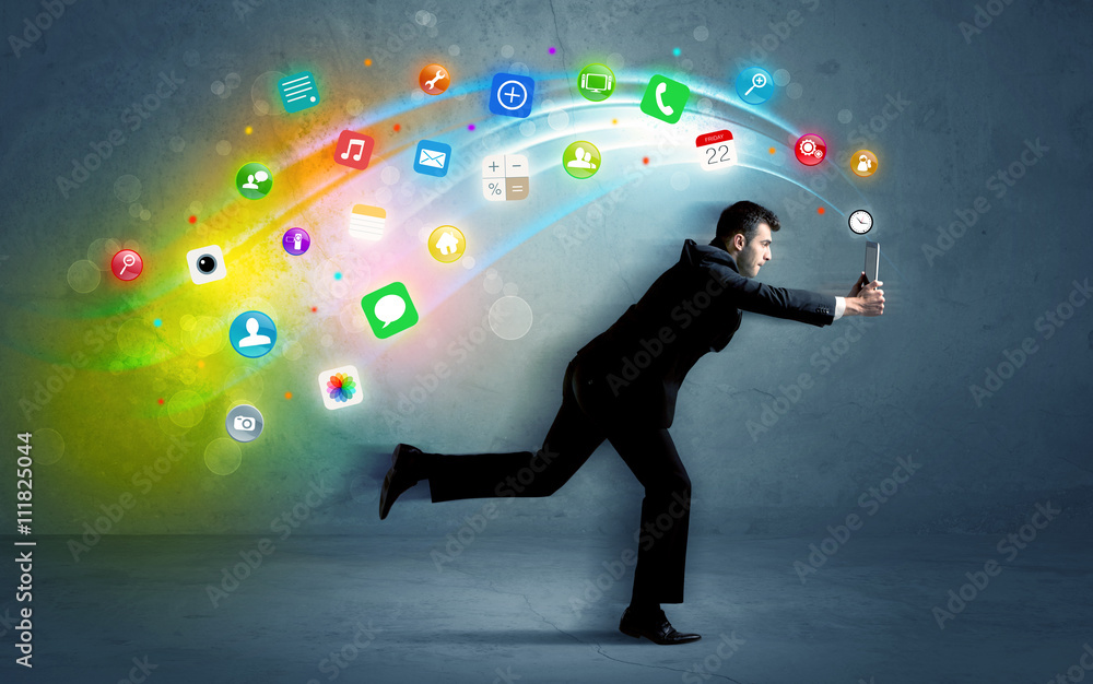 Running businessman with application icons from device Running businessman with application icons from device