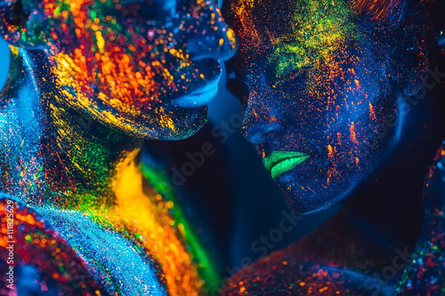 Canvas Print People are colored fluorescent powder. a pair of lovers dancing
