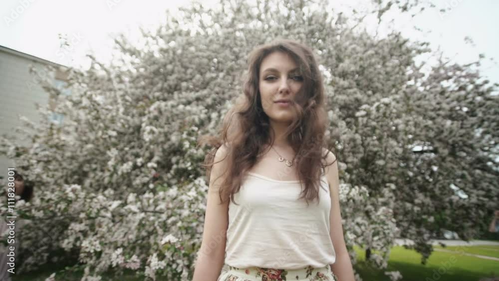Slow Motion. Beautiful natural woman in the garden of apple Slow Motion. Beautiful natural woman in the garden of apple