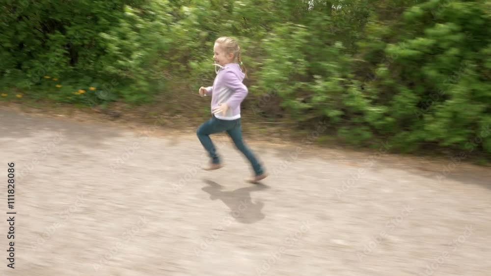 Playful little 5 years child girl runs on outdoor game laughs and smiles. Carefree childhood summer and happiness concept. 4K UHD video footage. Playful little 5 years child girl runs on outdoor game laughs and smiles. Carefree childhood summer and happiness concept. 4K UHD video footage.