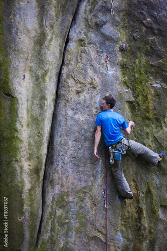 A rock climber climbs up the mountain.