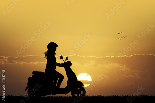 girl on scooter at sunset