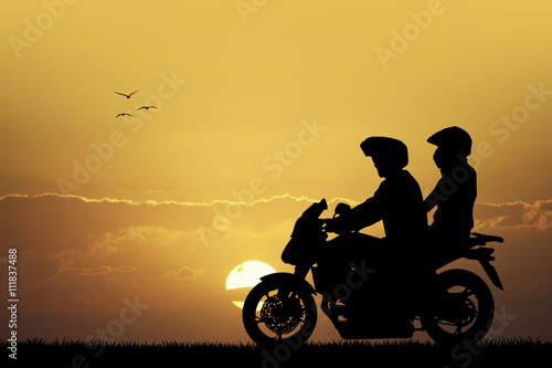 couple on motorcycle at sunset