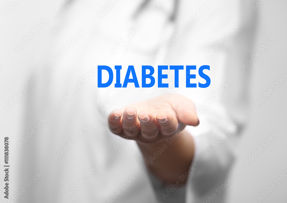 Young female doctor with text diabetes on hand Young female doctor with text diabetes on hand