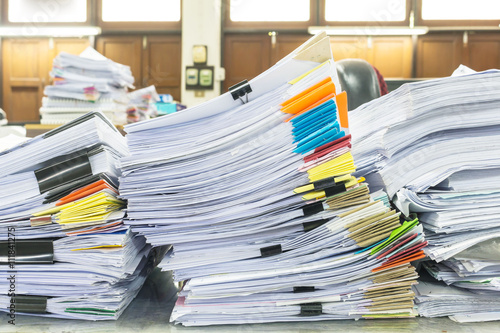 Pile of documents with colorful clips on desk stack up © notwaew
