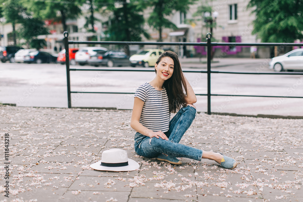 Beautiful and stylish girl with a hat posing outdoors. Beautiful and stylish girl with a hat posing outdoors.