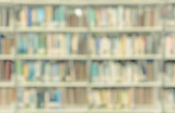 Blurred abstract background of library with bookshelves in school or university. Vintage color effect image.