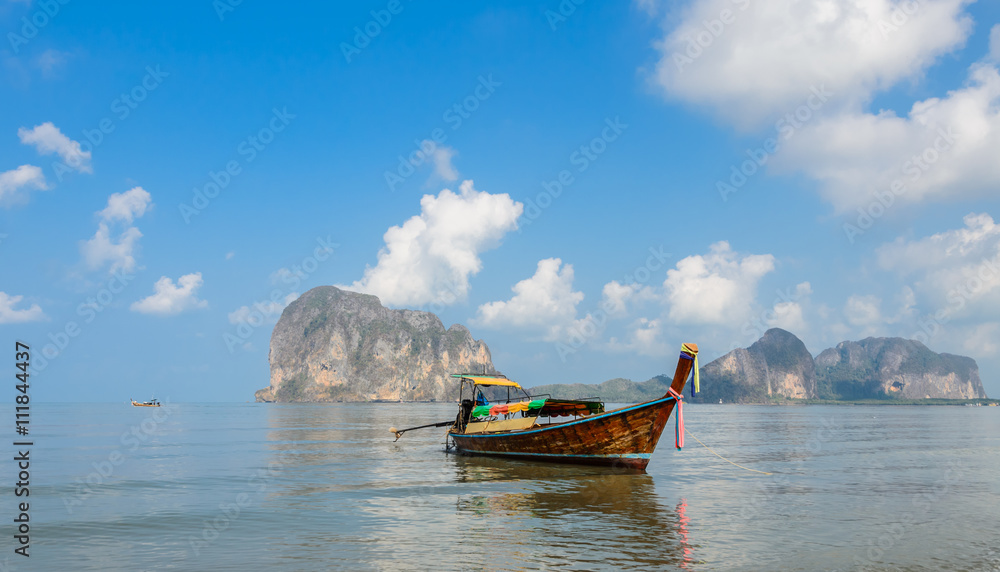 Beautiful Landscape of Pak Meng beach with long-tail wooden boat  and limestone mountain in Trang, Thailand