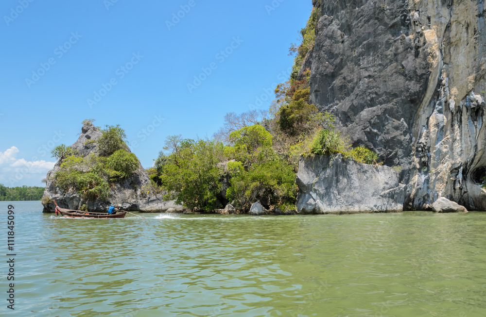 Limestone mountain with long-tailed boat in Phang Nga Province, Thailand