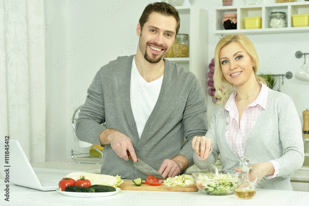 happy couple cooking in kitchen happy couple cooking in kitchen