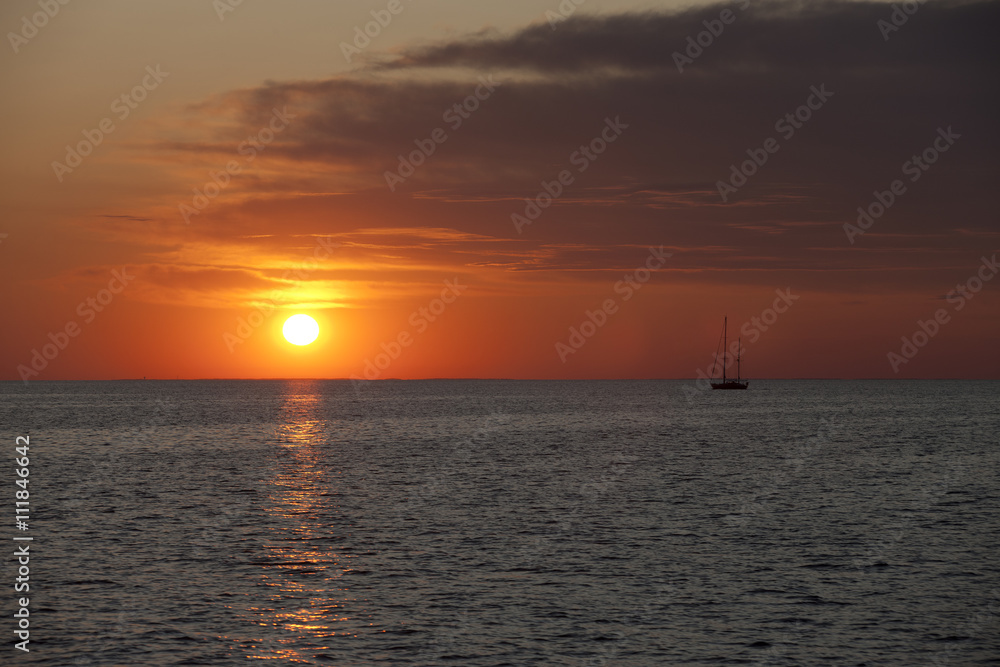 image of watercraft in sea at sunset. image of watercraft in sea at sunset.