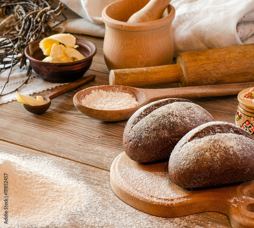 Freshly baked bread, flour and cooking utensils