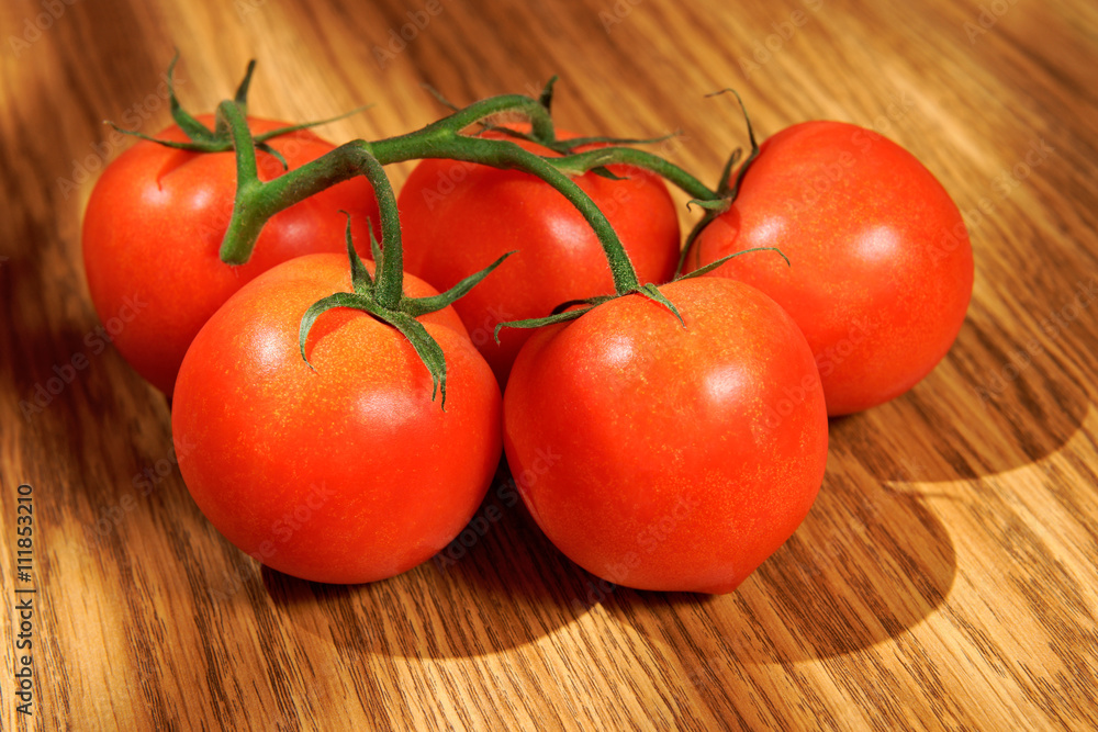 Tomatoes, bunch of vegetables on a wooden table Tomatoes, bunch of vegetables on a wooden table