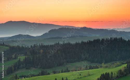 Moments before sunrise in misty Carpathian mountains, spring, Poland © tomeyk