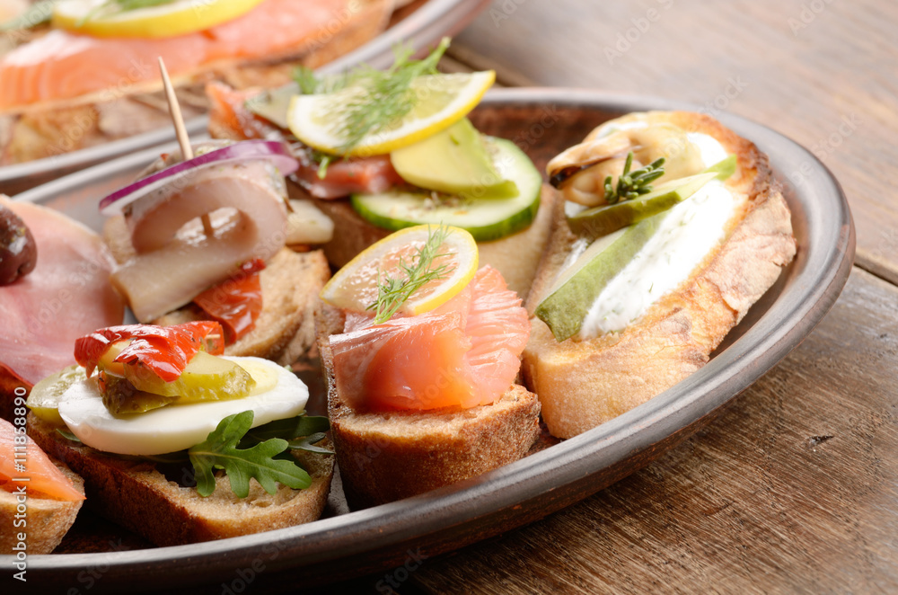 Open sandwiches with salmon, eggs, mussels, jamon and herring Open sandwiches with salmon, eggs, mussels, jamon and herring