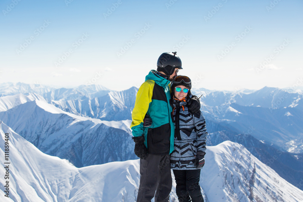 Couple in love snowboarder snowboarding on fresh white snow on ski slope on Sunny winter day
