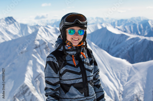 Girl snowboarder on fresh white snow on ski slope on Sunny winter day