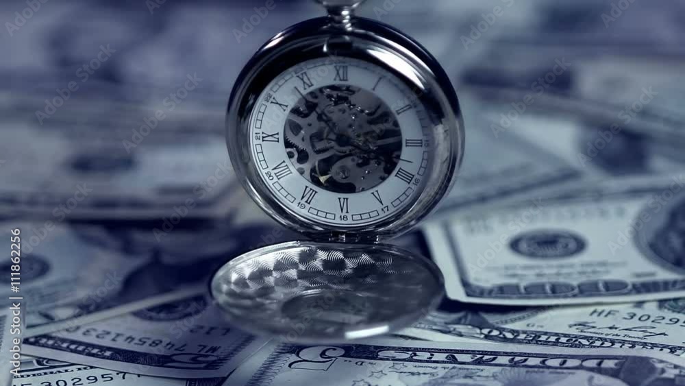 Pocket watch showing time, pile of US dollars, loan term approaching deadline Pocket watch showing time, pile of US dollars, loan term approaching deadline