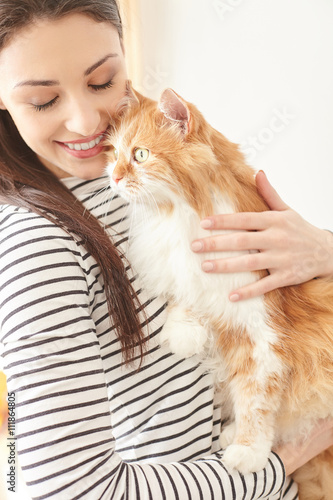 Cheerful girl is hugging her lovely pet