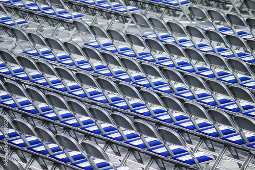 Rows of blue folding chairs for ceremony 