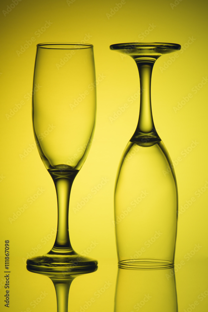 Two empty glasses in yellow light Two empty glasses in yellow light