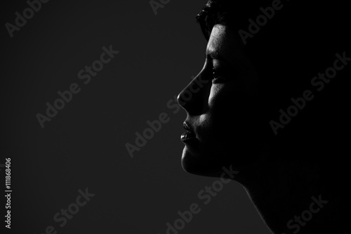 Abstract silhouette of young pretty woman looking away. Profile view.