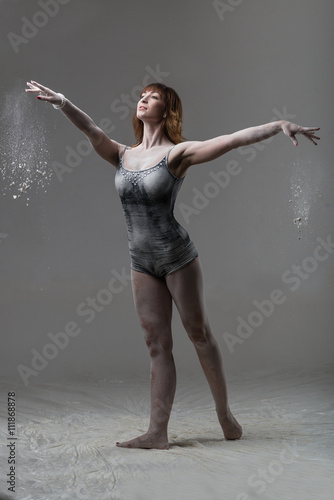 Fototapeta Naklejka Na Ścianę i Meble -  Beautiful expressive ballet dancer posing with flour at studio