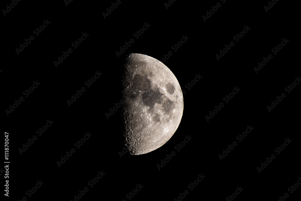 Half moon in black sky, detailed view of the surface. Half moon in black sky, detailed view of the surface.