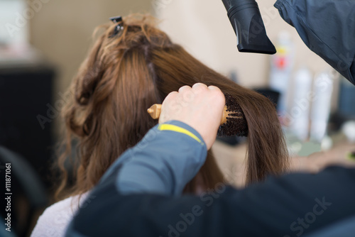 Stylist brushing hair,under exposed photo