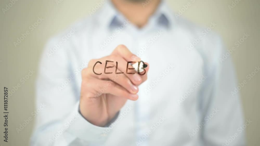 Celebrate Success , man writing on transparent wall Celebrate Success , man writing on transparent wall