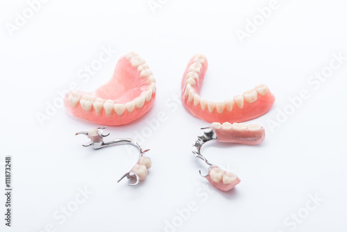 Set of dentures on white background photo