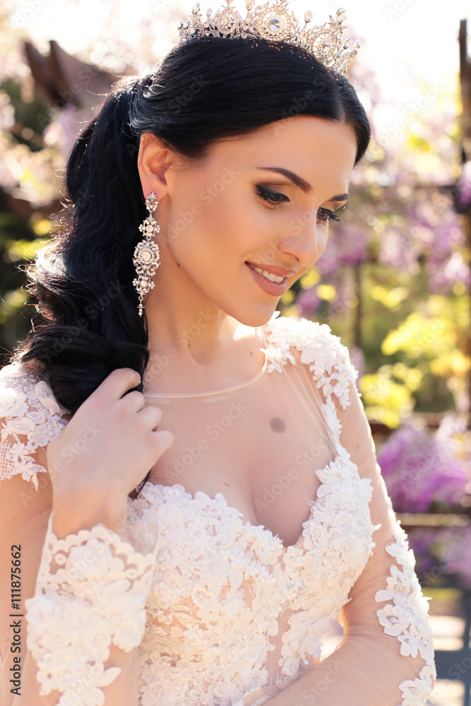 fashion outdoor photo of gorgeous bride in luxurious wedding dress, posing in blossom garden fashion outdoor photo of gorgeous bride in luxurious wedding dress, posing in blossom garden