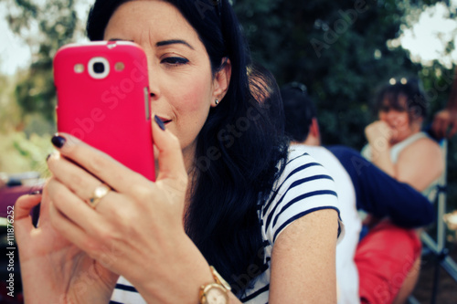 Woman taking picture with her cell phone